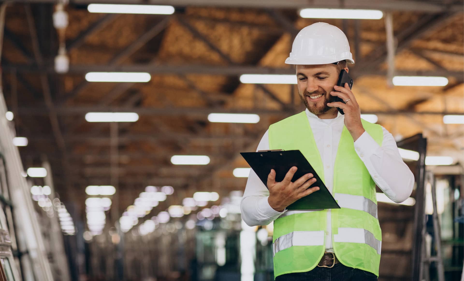 young-man-engineer-working-factory-making-order-phone@2x.jpg